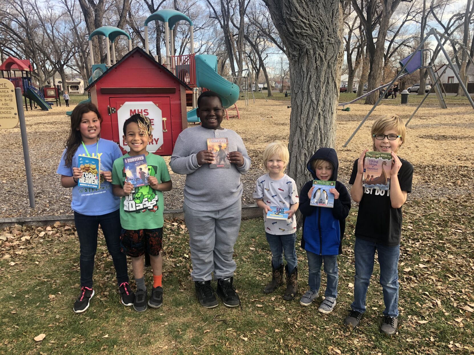 Children picking up books